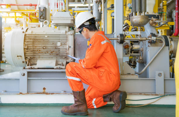 Photo of U.S. industrial worker examining an aging motor system.